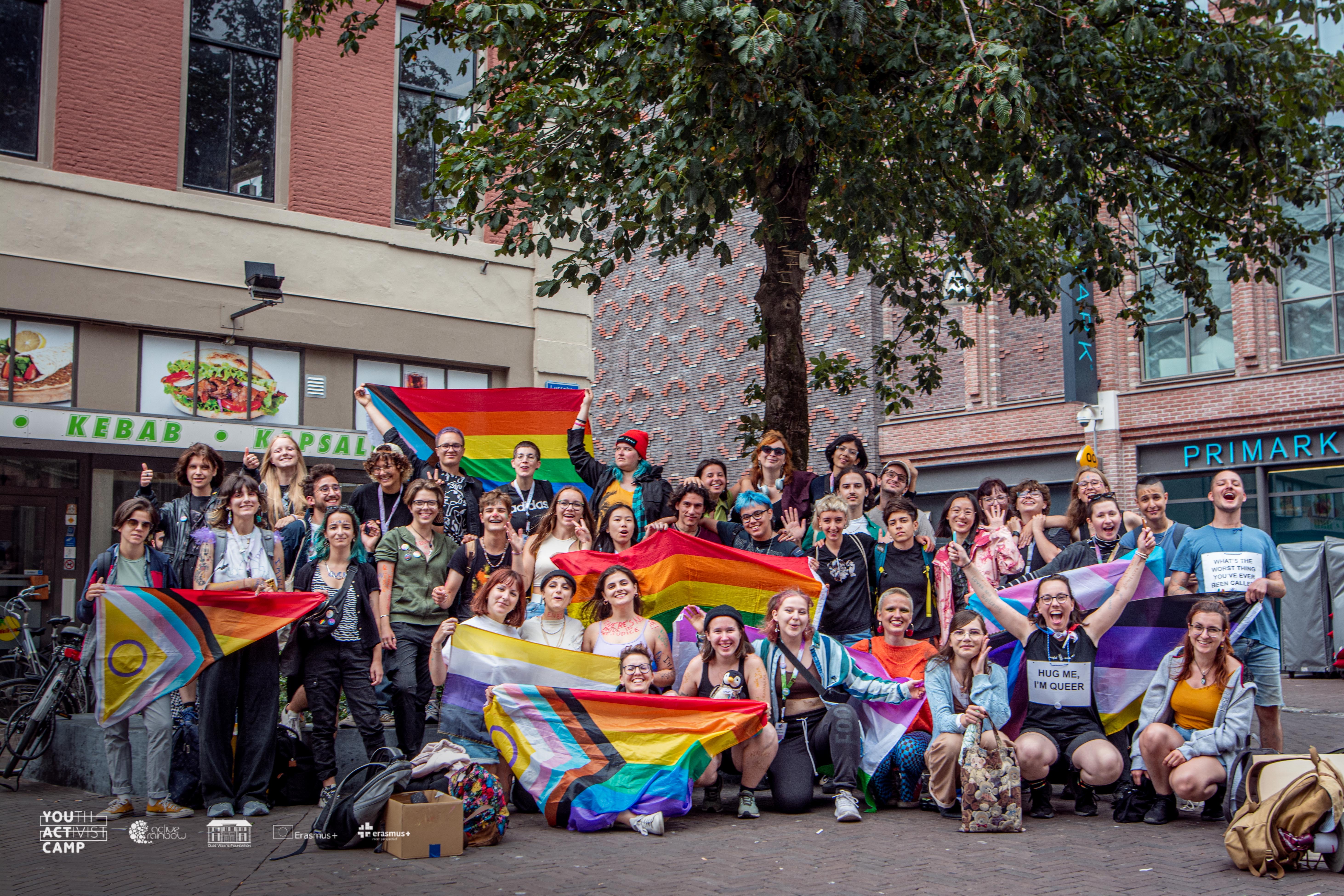 A group photo of youngsters with rainbow flags in the city Zwolle.